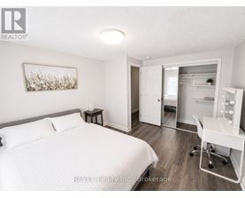 A bedroom with a bed, desk, and chair.