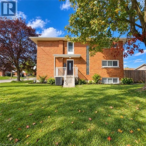 A house with a lawn and trees in front of it.