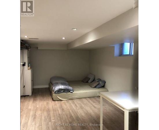 A bedroom with a bed and a table.