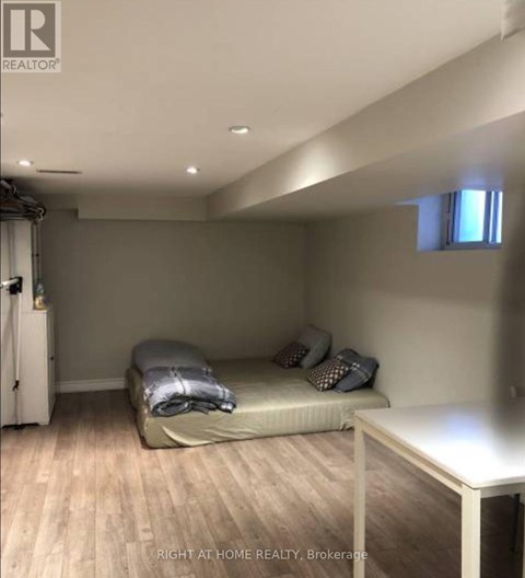 A bedroom with a bed and a table.