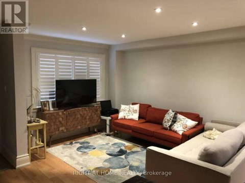 A living room with a red couch and a television.
