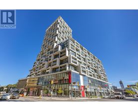 A tall building with a glass facade and a sign that says REALTOR.