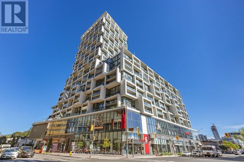 A tall building with a glass facade and a sign that says REALTOR.