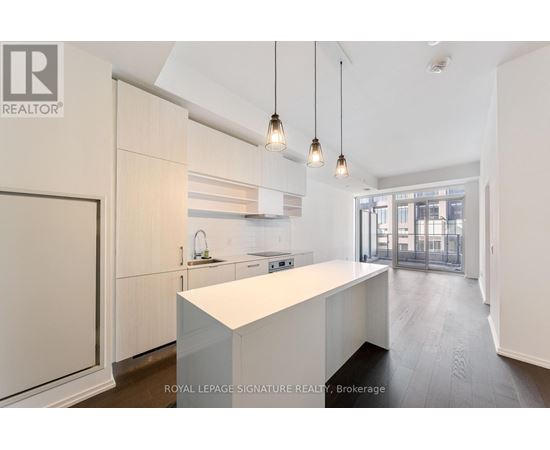 A modern kitchen with white cabinets and a central island.