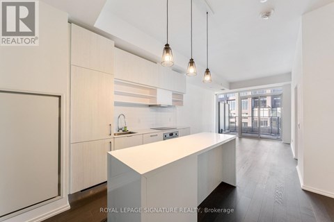 A modern kitchen with white cabinets and a central island.
