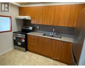 A kitchen with wooden cabinets and a black oven.