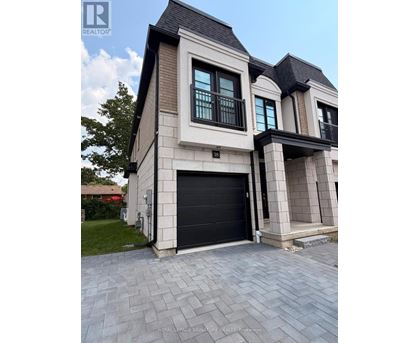 A modern two-story house with a black garage door.