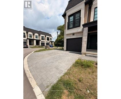 A real estate photo of a house with a driveway.