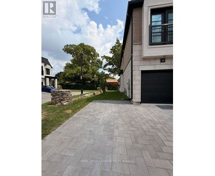 A residential area with a house numbered 35 and a stone wall.