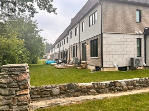 A building with a stone wall in front of it.
