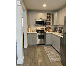 A kitchen with white cabinets and stainless steel appliances.
