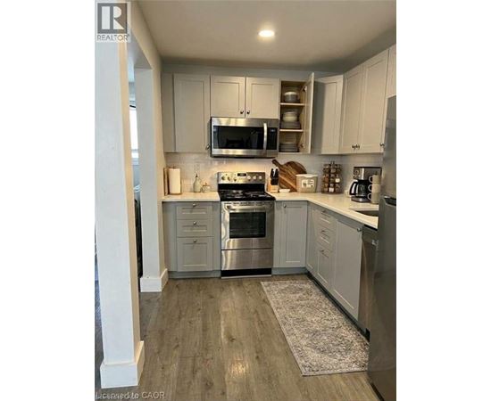 A kitchen with white cabinets and stainless steel appliances.