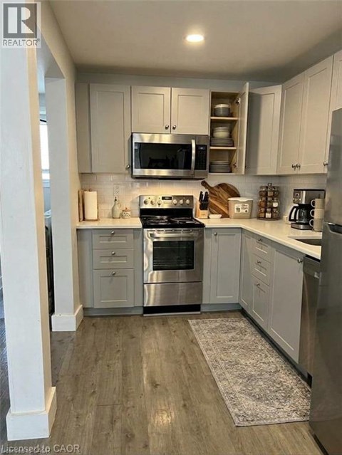 A kitchen with white cabinets and stainless steel appliances.