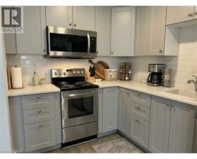 A kitchen with a stove top oven and microwave above it.