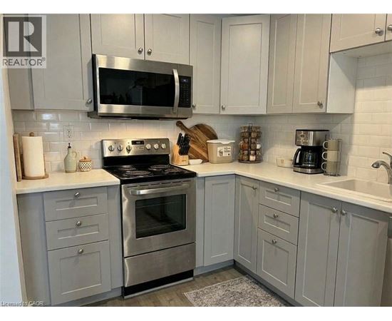 A kitchen with a stove top oven and microwave above it.