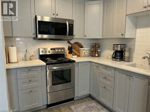 A kitchen with a stove top oven and microwave above it.