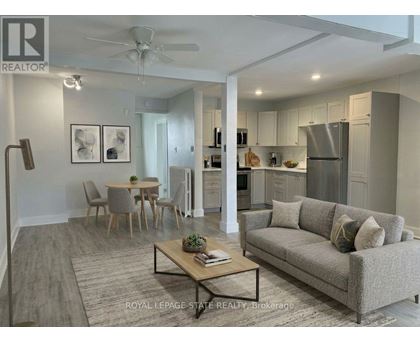 A well-lit, modern living room with a grey couch and a coffee table.