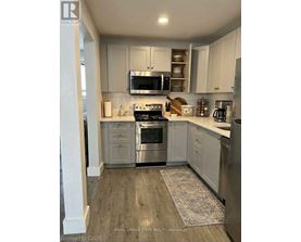 A kitchen with white cabinets and stainless steel appliances.