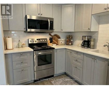 A kitchen with a stove, microwave, and cabinets.