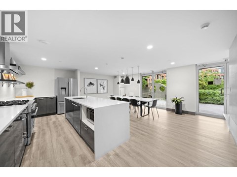 A modern kitchen with a dining area and a large window.