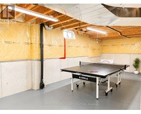 A room with a Joola table tennis table in the middle.