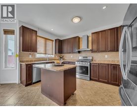 A kitchen with brown cabinets and a large island.