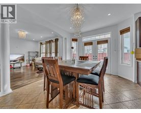 A dining room with a wooden table and chairs.