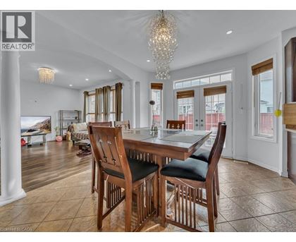 A dining room with a wooden table and chairs.