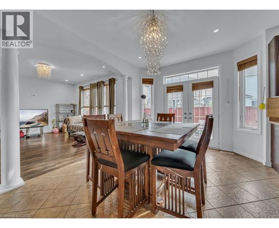 A dining room with a wooden table and chairs.