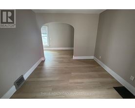 A room with a wooden floor and a window.