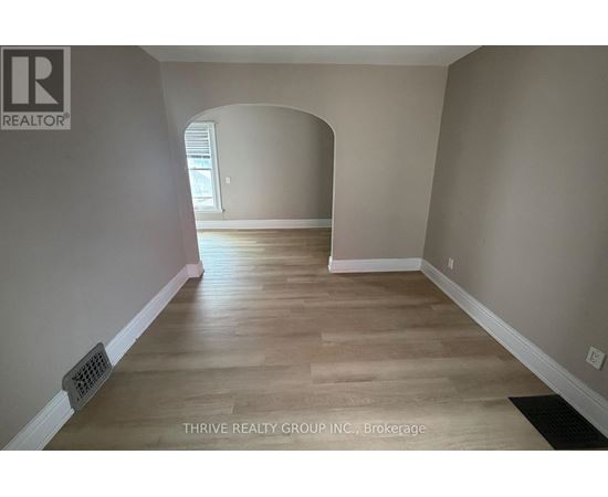 A room with a wooden floor and a window.