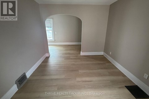 A room with a wooden floor and a window.