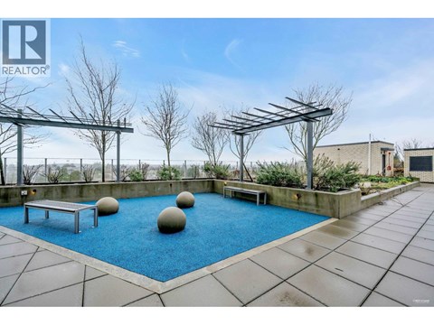 A pool with a bench and a ball in the middle of it.