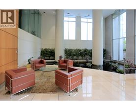 A lobby area with a glass wall and a sign that says REALTOR.