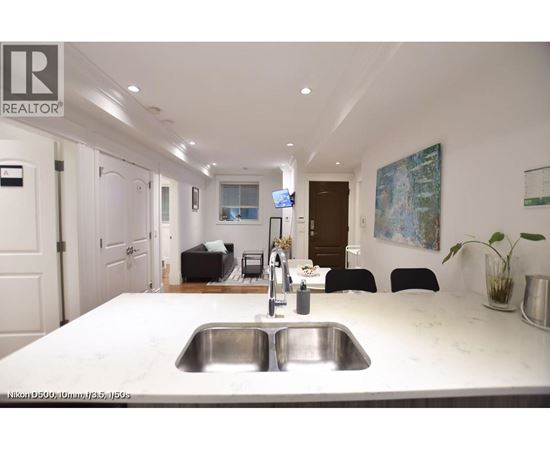 A kitchen with a sink and a counter.