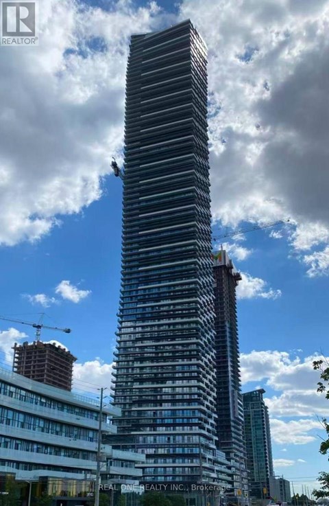 A tall building under construction with a crane on the left side.