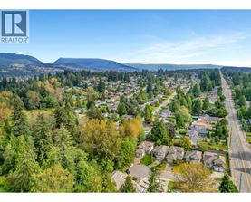A realtor logo is on a picture of a suburban neighborhood.