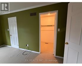 A room with green walls and a white door.