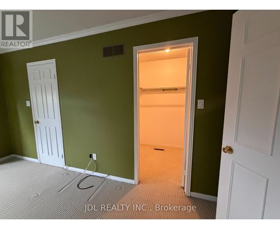 A room with green walls and a white door.
