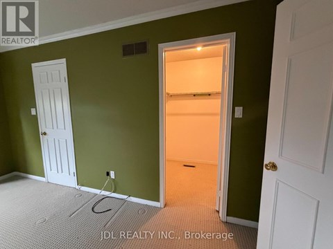 A room with green walls and a white door.