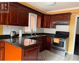 A kitchen with wooden cabinets and a black countertop.