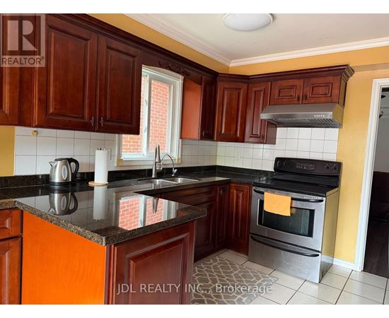 A kitchen with wooden cabinets and a black countertop.