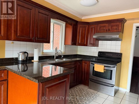 A kitchen with wooden cabinets and a black countertop.