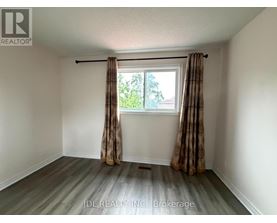 A room with a window and curtains, and a logo that says "REALTOR".