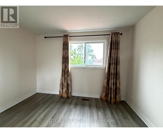 A room with a window and curtains, and a logo that says "REALTOR".