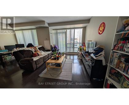 A living room with a couch, a coffee table, and a bookshelf.