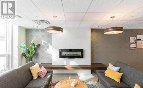 A living room with a grey couch and a wooden coffee table.