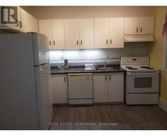 A kitchen with white appliances and cabinets.