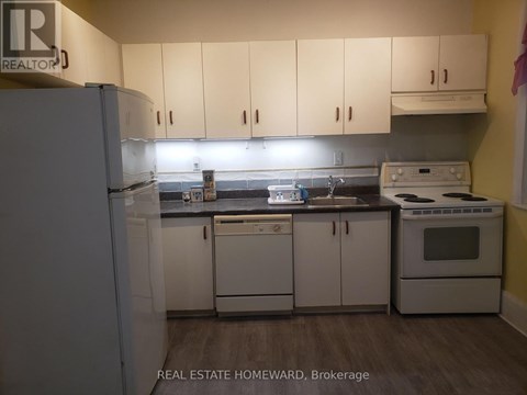A kitchen with white appliances and cabinets.