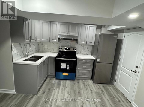 A kitchen with a blue bin in the middle.